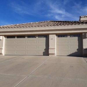 Image of tan garage door expertly installed by A1 Garage Door Service.