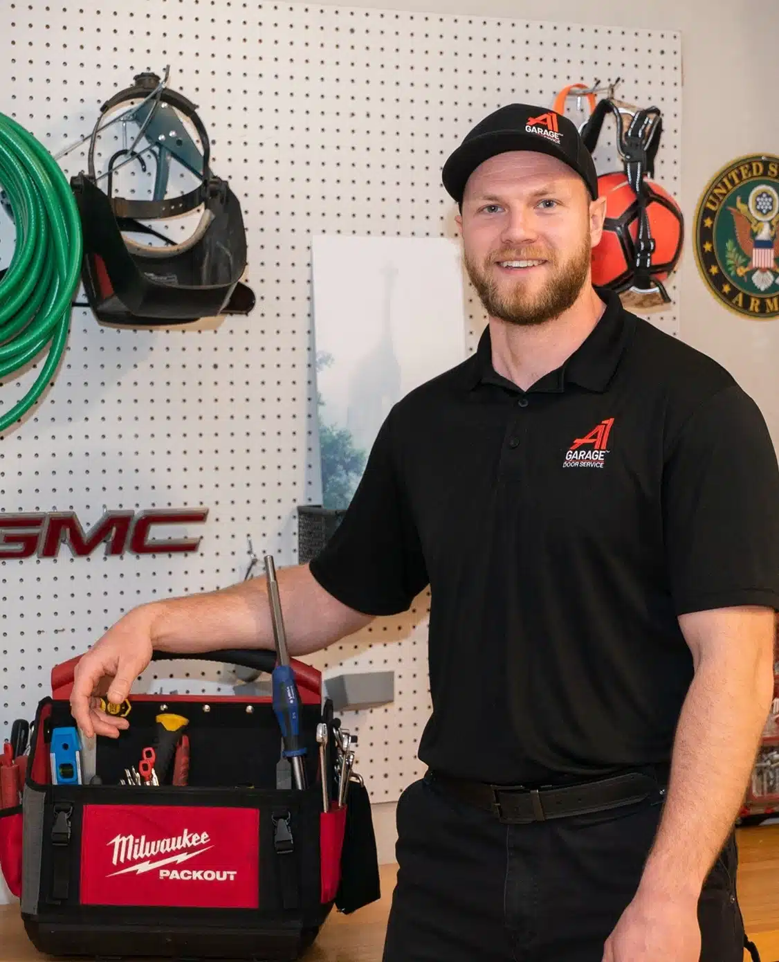 A1 Garage Door Service technician repairing garage door with tools