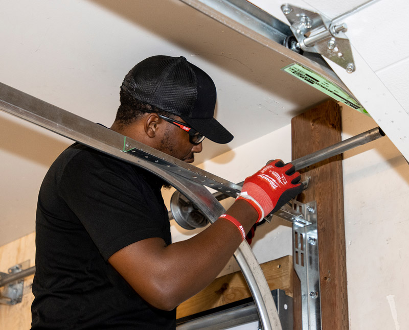Technician training on a garage door